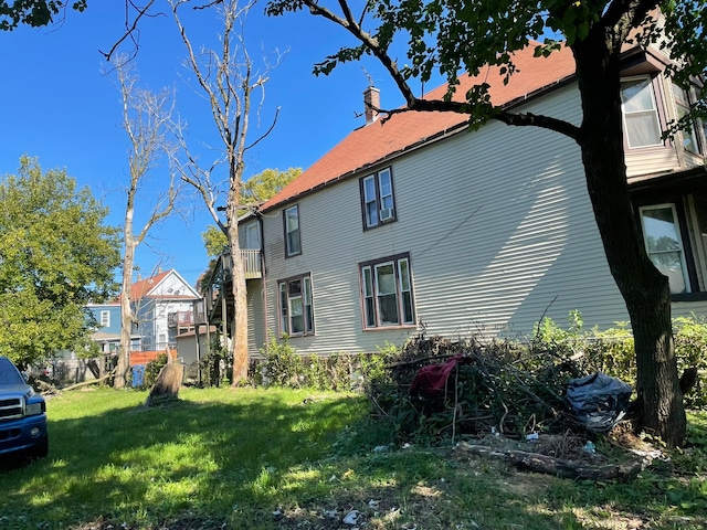 view of property exterior with a lawn