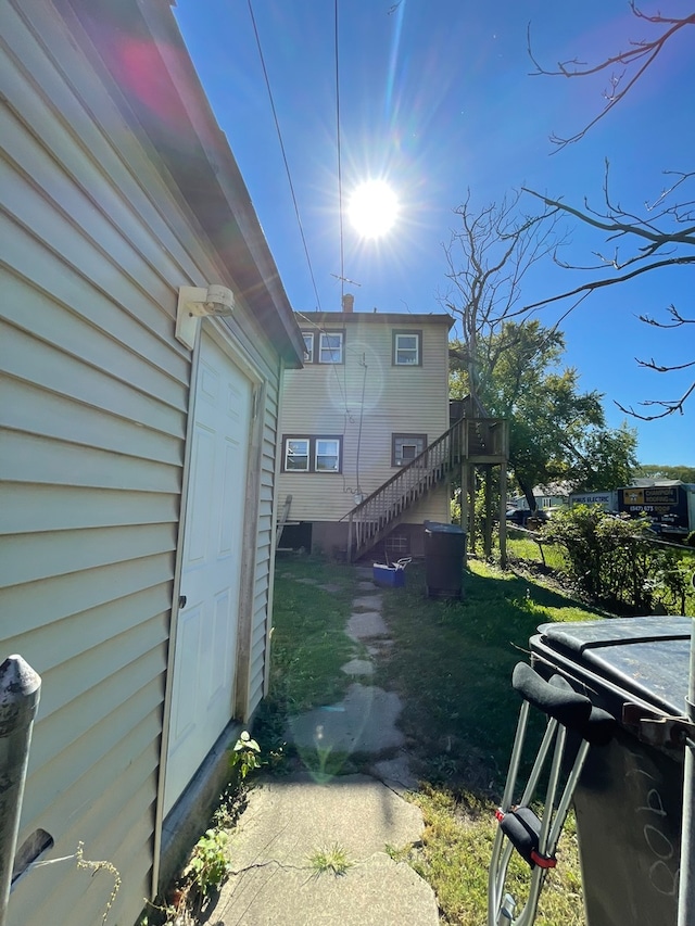 view of side of home with a lawn