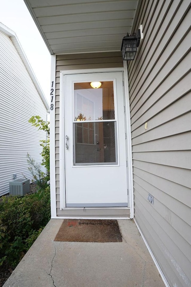 property entrance featuring central AC unit