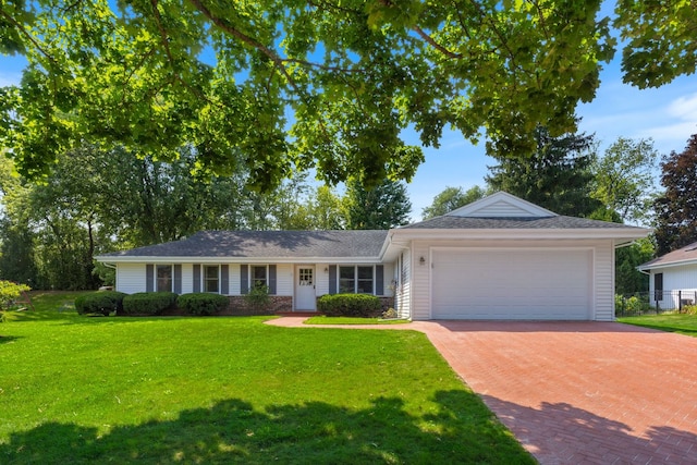 ranch-style home with a front yard and a garage