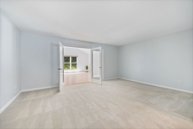 spare room featuring light colored carpet