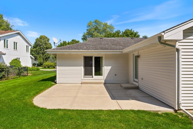 rear view of house featuring a lawn and a patio area