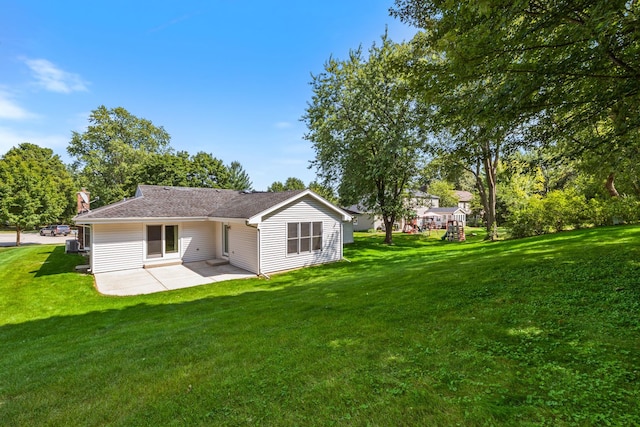 rear view of house with a lawn and a patio area