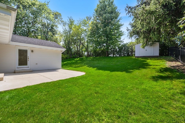 view of yard featuring a storage shed and a patio