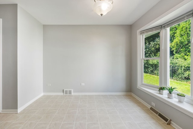 unfurnished room featuring a healthy amount of sunlight