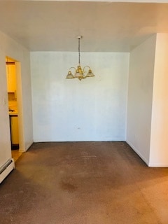 spare room featuring baseboard heating, a chandelier, and dark colored carpet