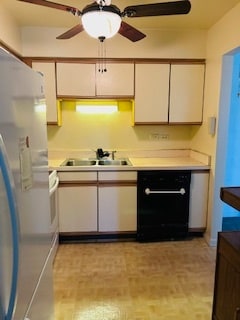 kitchen featuring black dishwasher, sink, white cabinets, white fridge, and ceiling fan