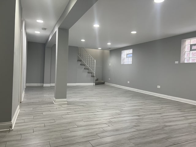 basement with light hardwood / wood-style flooring