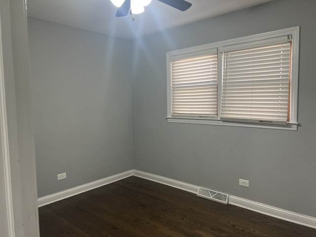 unfurnished room featuring plenty of natural light, ceiling fan, and dark hardwood / wood-style flooring