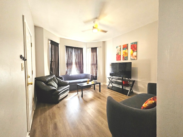 living room featuring ceiling fan and light hardwood / wood-style flooring