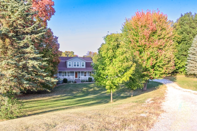 view of front facade with a front lawn and covered porch