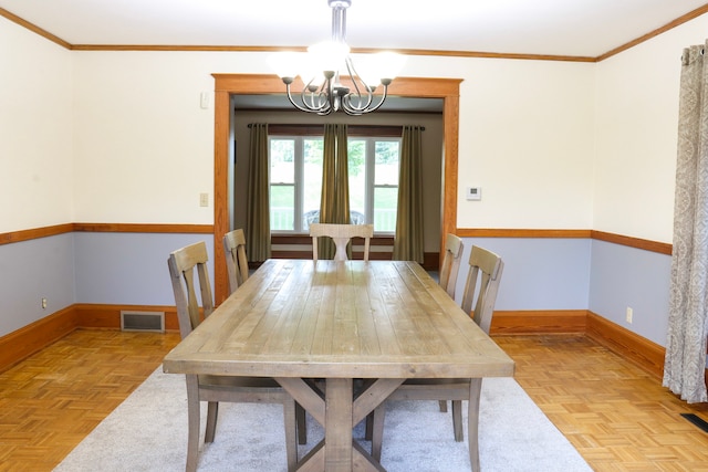 unfurnished dining area featuring crown molding, light parquet floors, and a chandelier