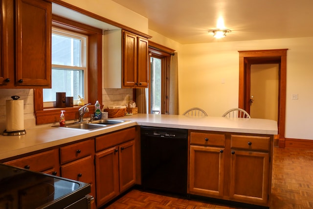 kitchen with sink, kitchen peninsula, backsplash, dishwasher, and a wealth of natural light