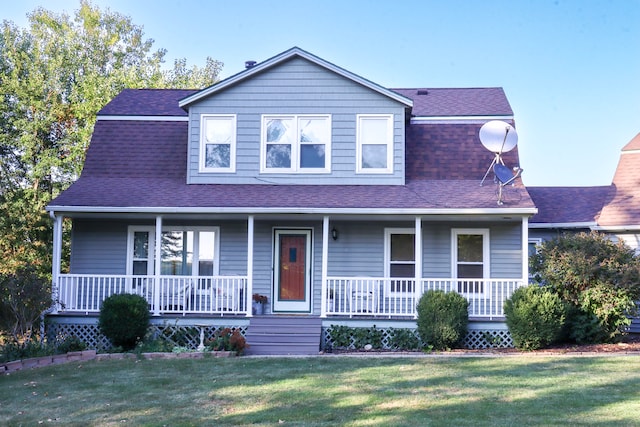 view of front of house with a front yard and covered porch