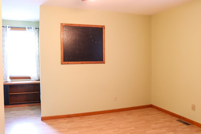 empty room featuring a wealth of natural light and light hardwood / wood-style floors