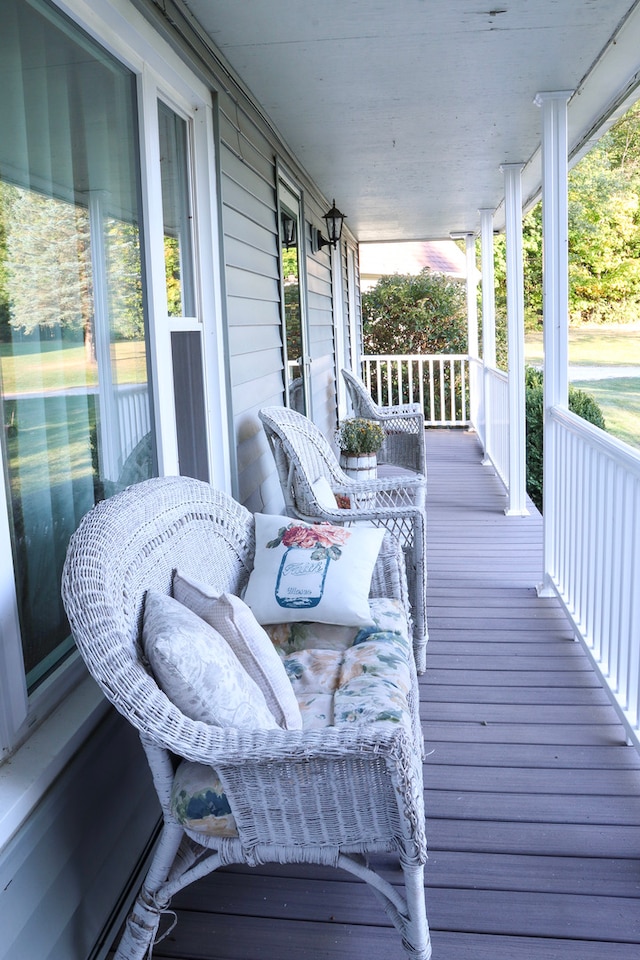 wooden terrace featuring covered porch