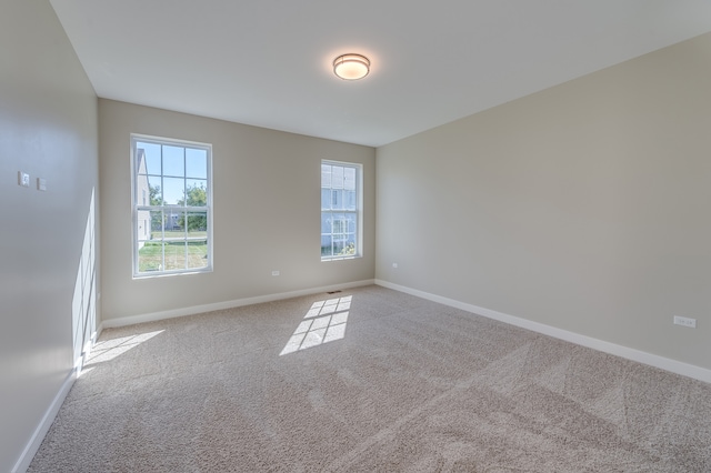 unfurnished room featuring light colored carpet