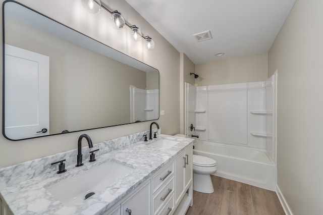 full bathroom with bathing tub / shower combination, vanity, toilet, and hardwood / wood-style flooring