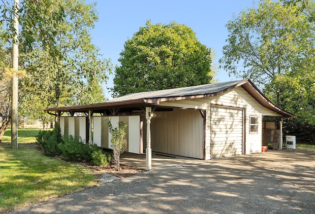 26811 S Kankakee St, Manhattan, IL 60442 - view of property's community with an outdoor structure, asphalt driveway, and a yard