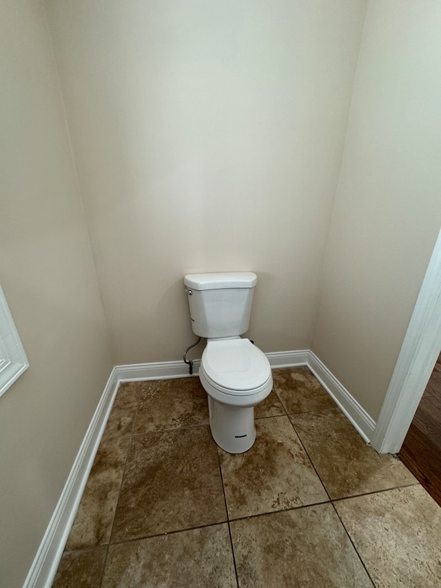 bathroom with tile patterned flooring and toilet