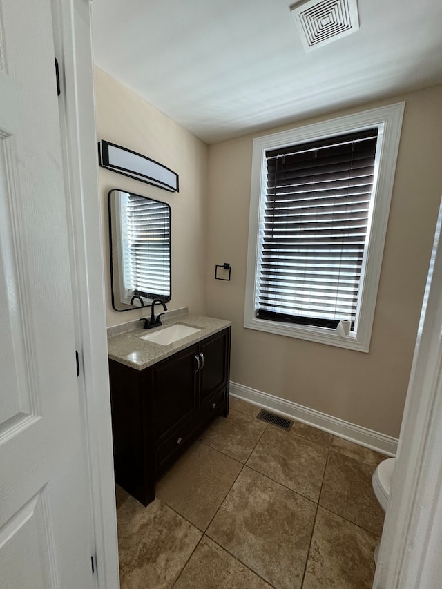 bathroom featuring tile patterned floors, toilet, and vanity