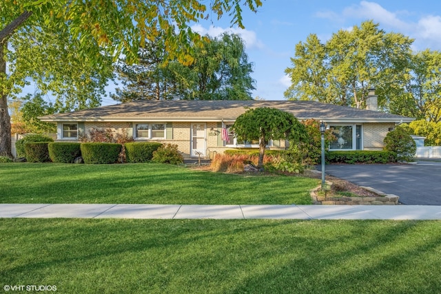 ranch-style house with a front lawn