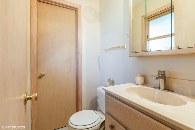 bathroom featuring toilet and vanity