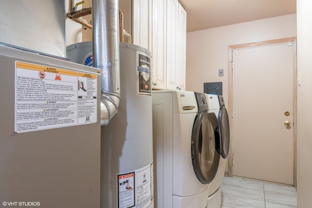 laundry room featuring gas water heater, washing machine and dryer, and cabinets