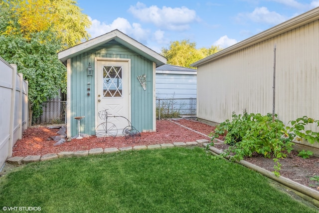 view of outbuilding featuring a yard