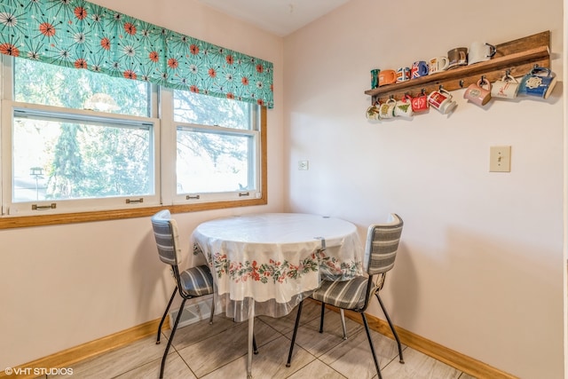 dining room featuring light wood-type flooring and a healthy amount of sunlight