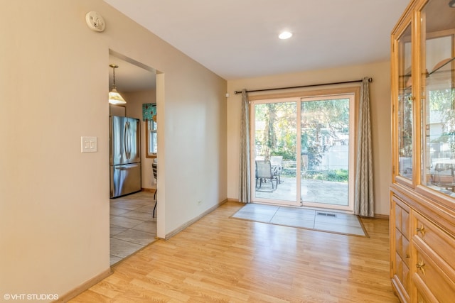 doorway to outside featuring light wood-type flooring