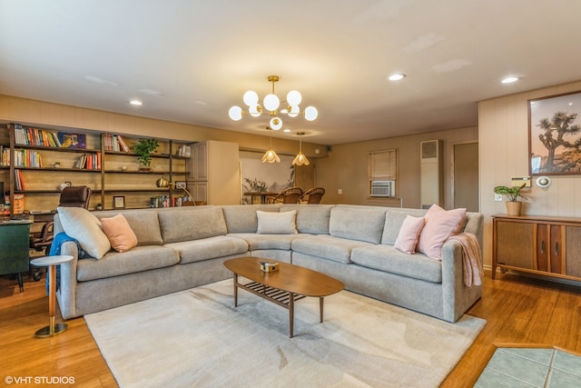 living room featuring hardwood / wood-style flooring and a notable chandelier