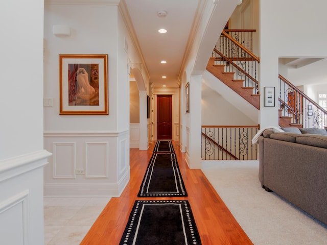 hall featuring crown molding and light hardwood / wood-style flooring