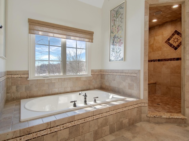 bathroom featuring plus walk in shower and tile patterned flooring