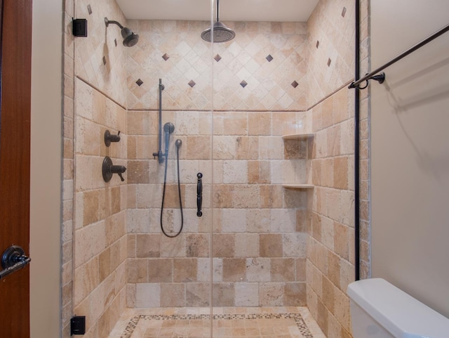 bathroom featuring an enclosed shower and toilet