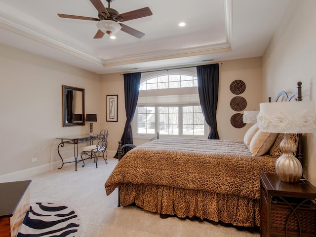 bedroom with ornamental molding, a raised ceiling, ceiling fan, and carpet flooring