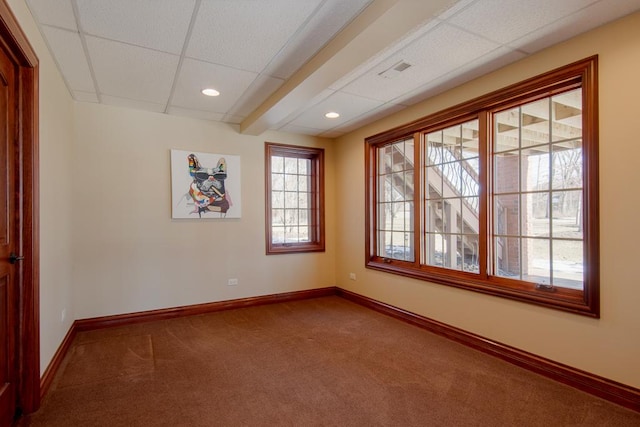 unfurnished room featuring carpet floors and a paneled ceiling