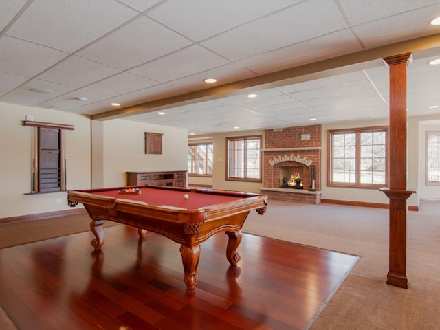 recreation room featuring decorative columns, a paneled ceiling, a fireplace, and pool table