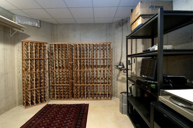 wine cellar featuring a paneled ceiling and concrete floors