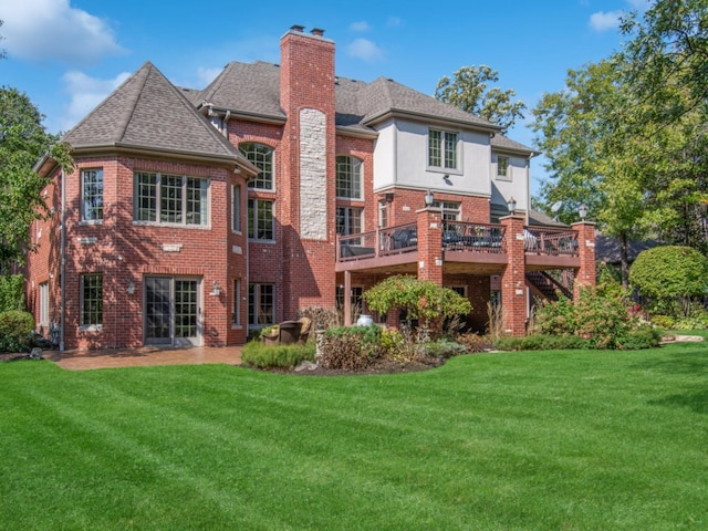 rear view of property featuring a yard and a deck