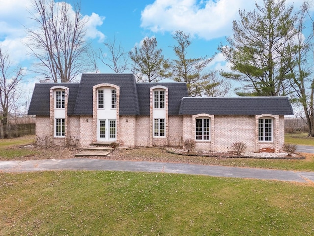 french country home featuring a front lawn