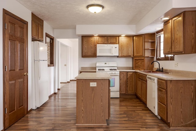 kitchen with a center island, sink, dark hardwood / wood-style flooring, a textured ceiling, and white appliances