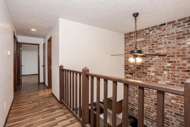 corridor featuring a textured ceiling and dark hardwood / wood-style floors