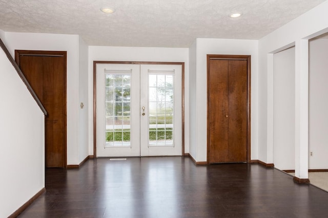 doorway featuring dark hardwood / wood-style flooring, a textured ceiling, and french doors