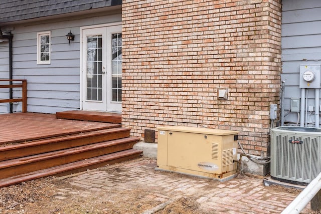 exterior space featuring french doors, a wooden deck, and central air condition unit