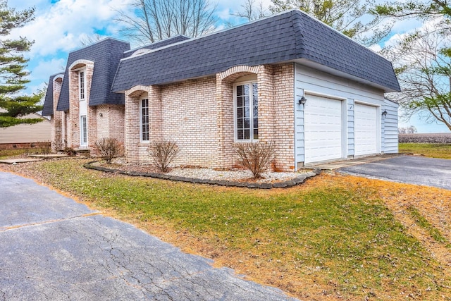 view of side of home featuring a lawn and a garage