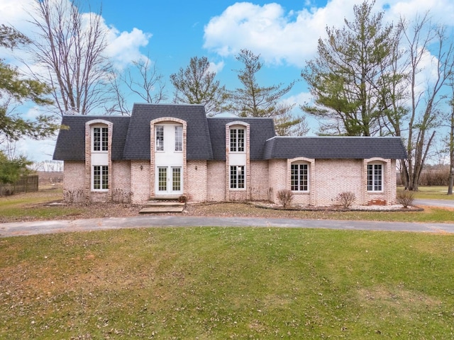 french country home featuring a front yard