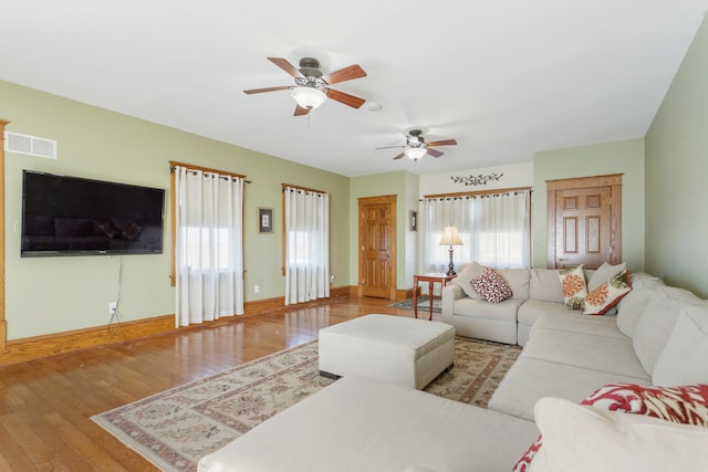 living room with light hardwood / wood-style floors, plenty of natural light, and ceiling fan