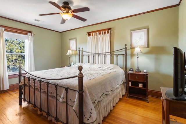 bedroom featuring crown molding, light wood-type flooring, and ceiling fan