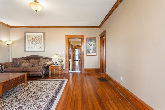 living room with hardwood / wood-style flooring and ornamental molding